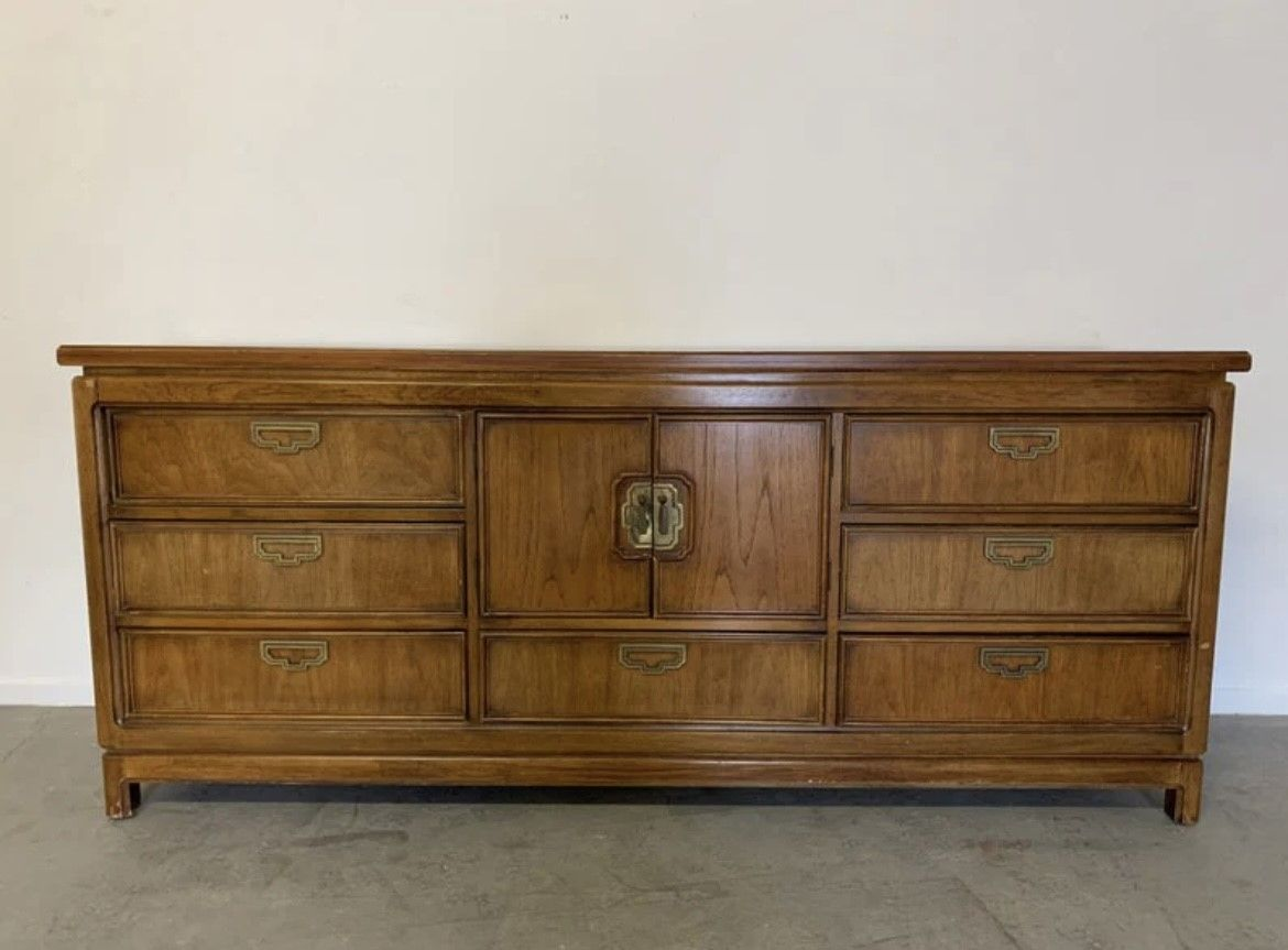 A large wooden dresser with many drawers.