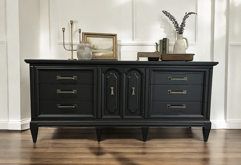 image 42 A black dresser with some drawers and a vase