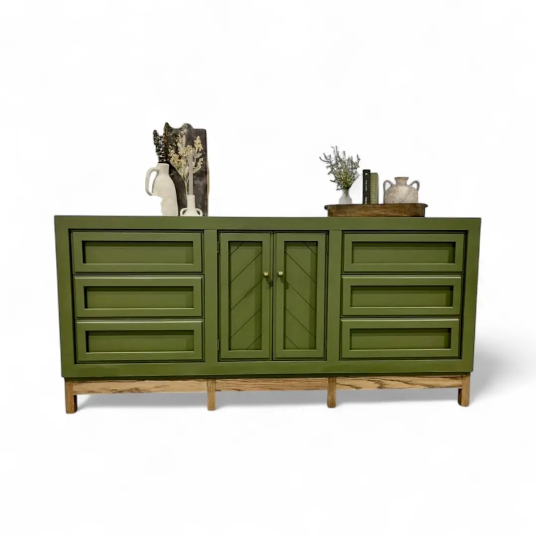 Green sideboard with decorative items on top.