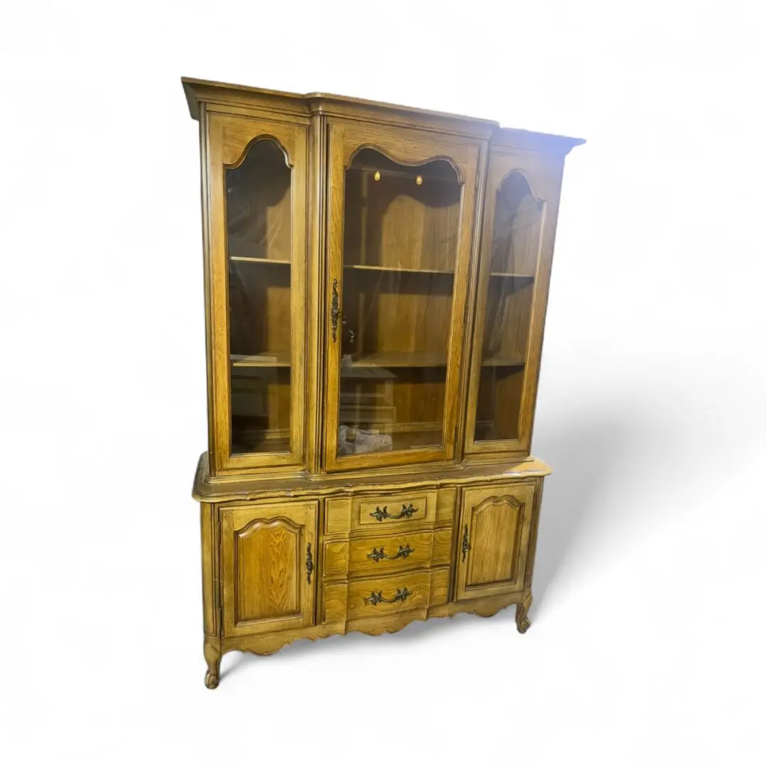 Wooden china cabinet with glass doors.