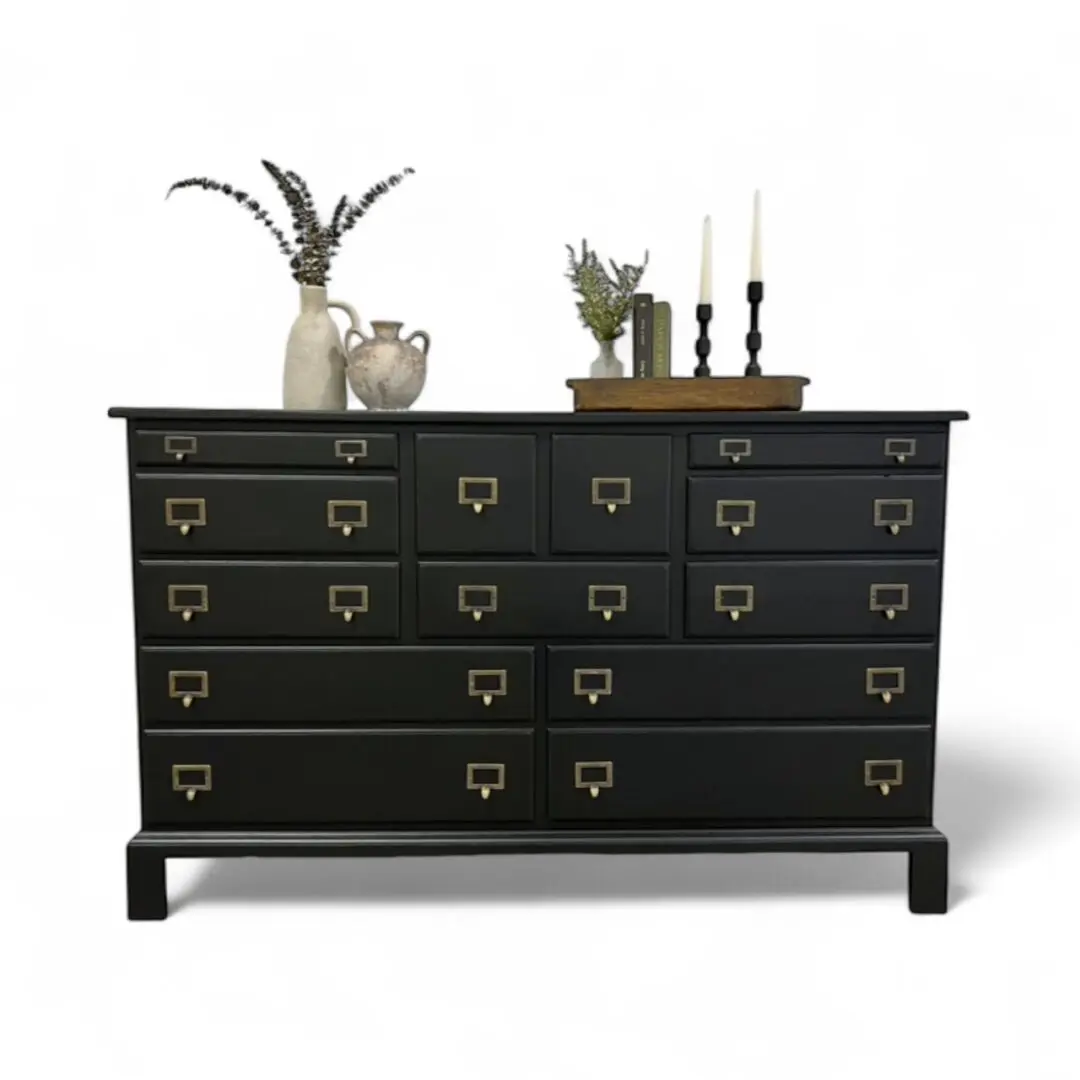 Black dresser with decorative items on top.