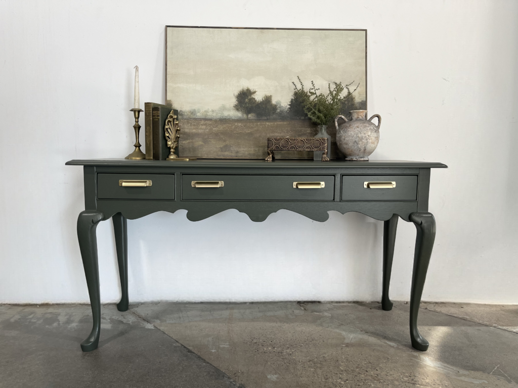 Dark gray console table with framed landscape